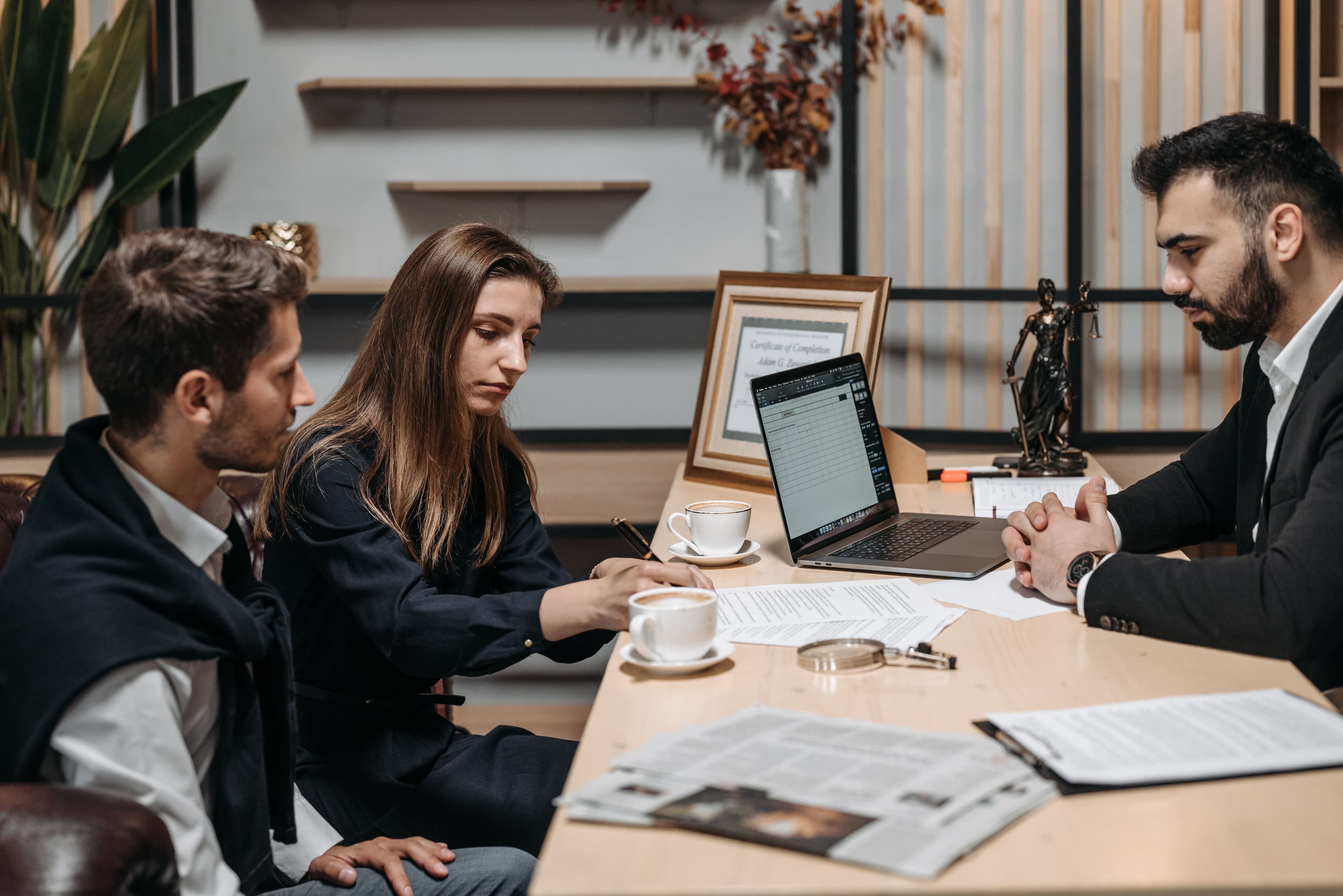 Professionals discussing documents while tracing where a claim came from